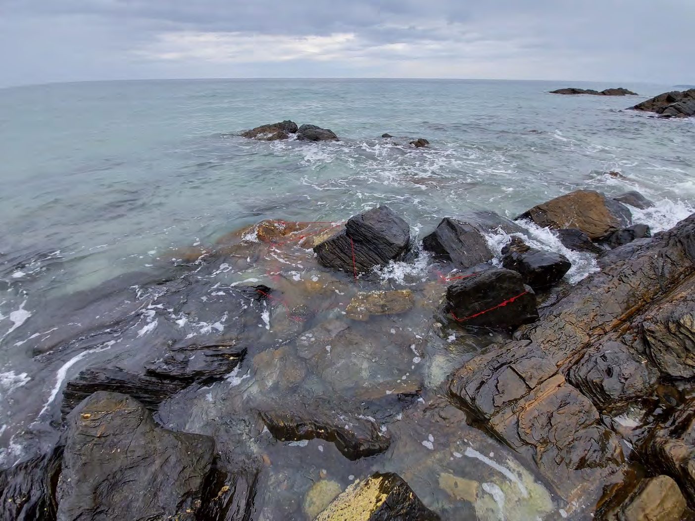 Rocks and yarn submerged by the incoming tide