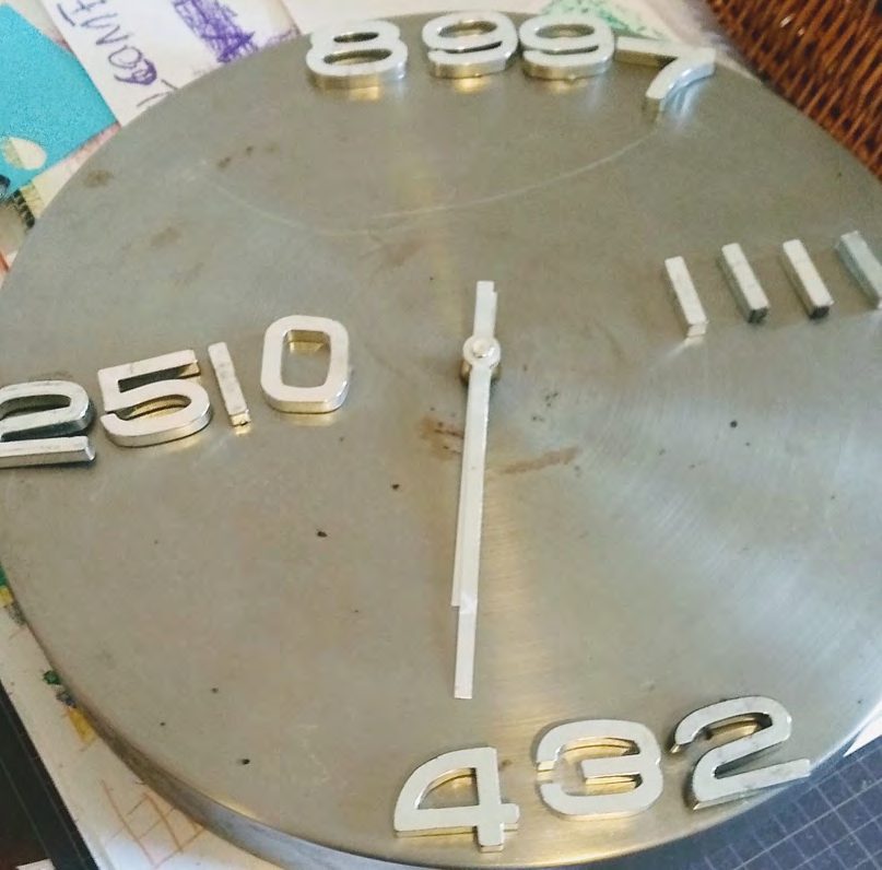 Close-up of a metal clock face with large numerals