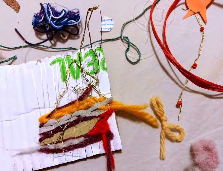 Coloured yarns woven through a card loom